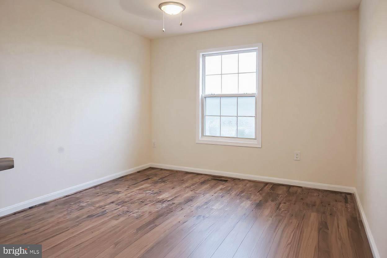 8461 Tackhouse Loop Gainesville, VA 20155 - Photo 20 of 39 an empty room with wooden floor and windows