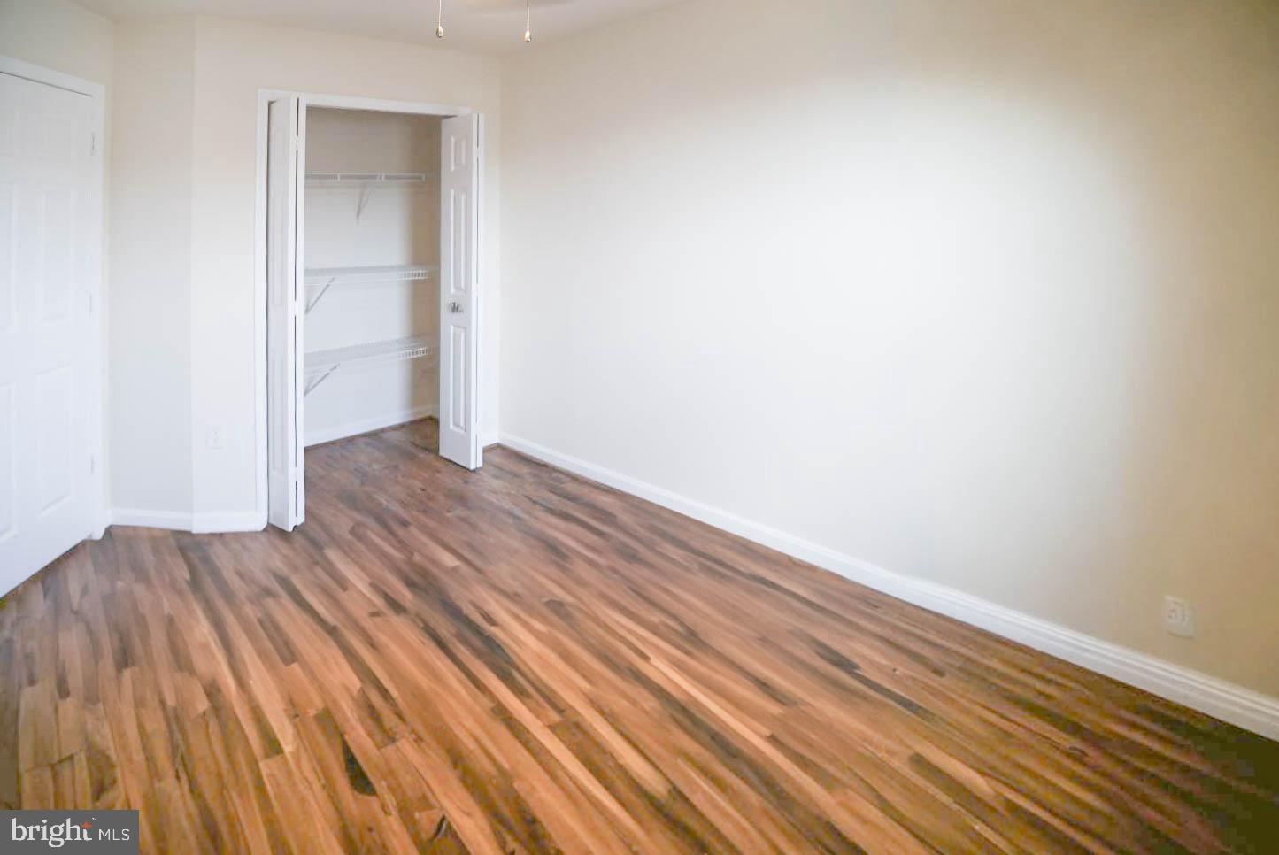8461 Tackhouse Loop Gainesville, VA 20155 - Photo 21 of 39 a view of an empty room with wooden floor