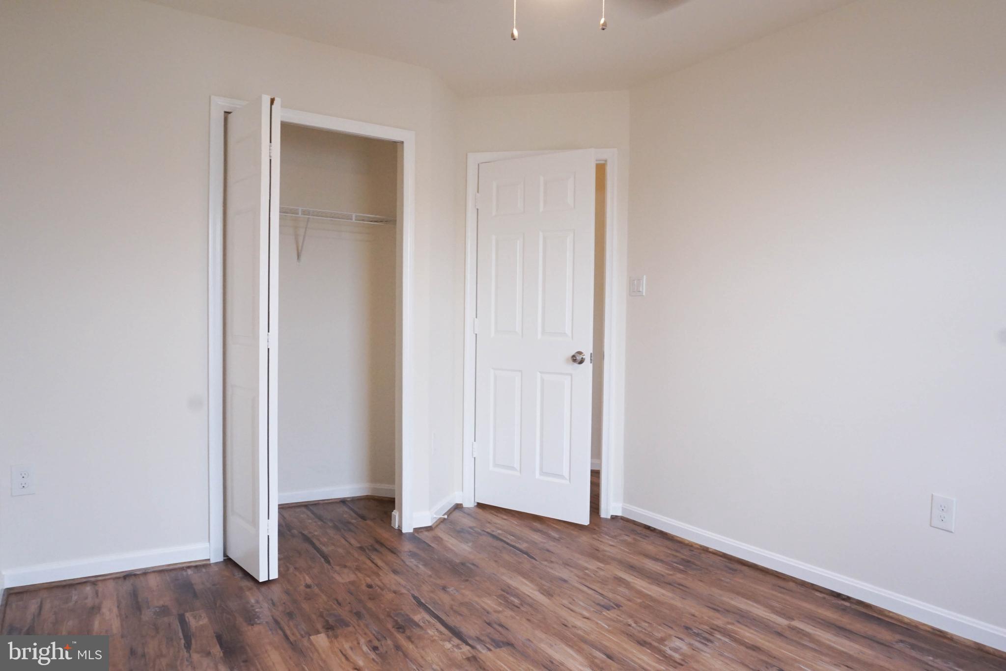 8461 Tackhouse Loop Gainesville, VA 20155 - Photo 24 of 39 a view of an empty room with wooden floor