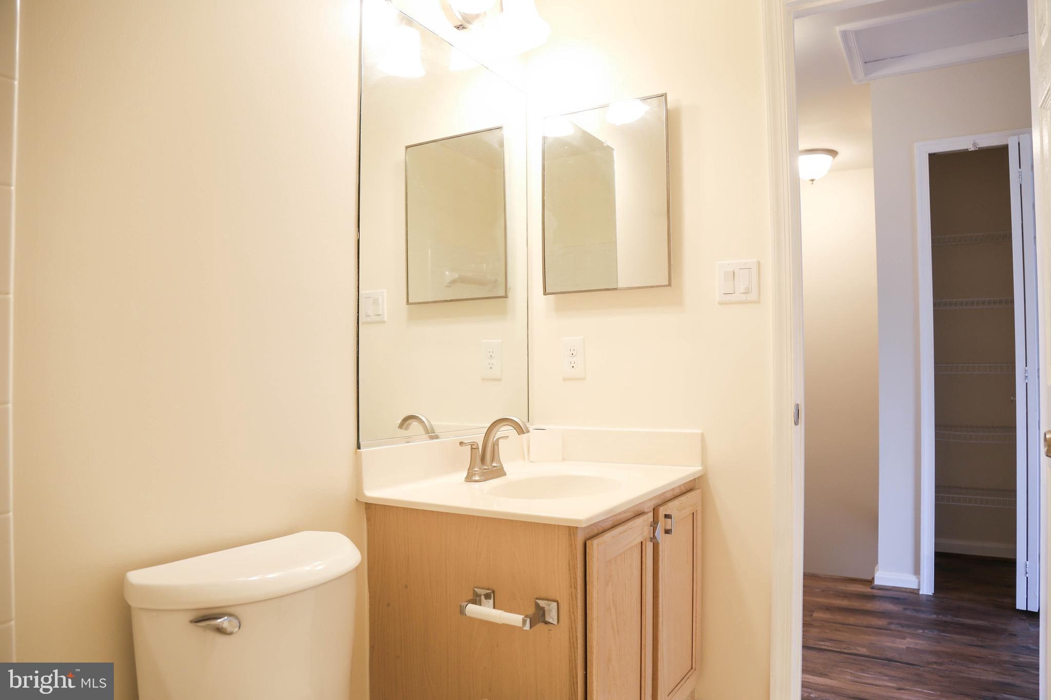 8461 Tackhouse Loop Gainesville, VA 20155 - Photo 26 of 39 a bathroom with a sink and a mirror