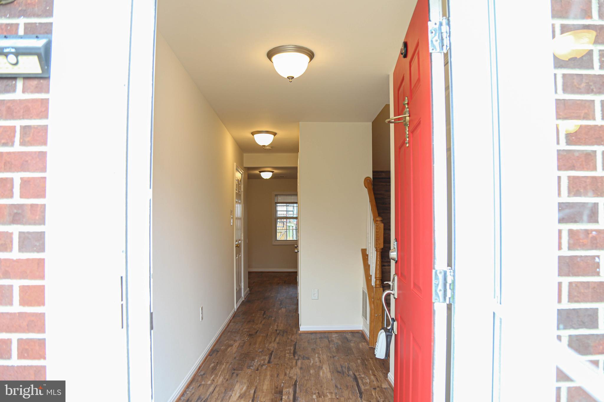 8461 Tackhouse Loop Gainesville, VA 20155 - Photo 27 of 39 a view of a hallway with wooden floor