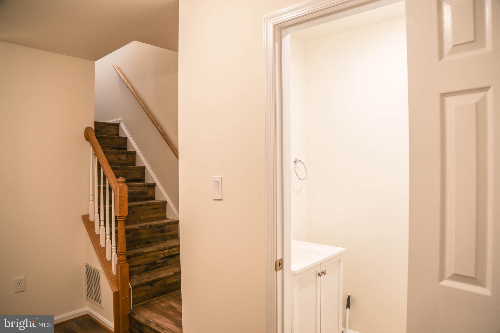 8461 Tackhouse Loop Gainesville, VA 20155 - Photo 28 of 39 a view of a hallway with stairs