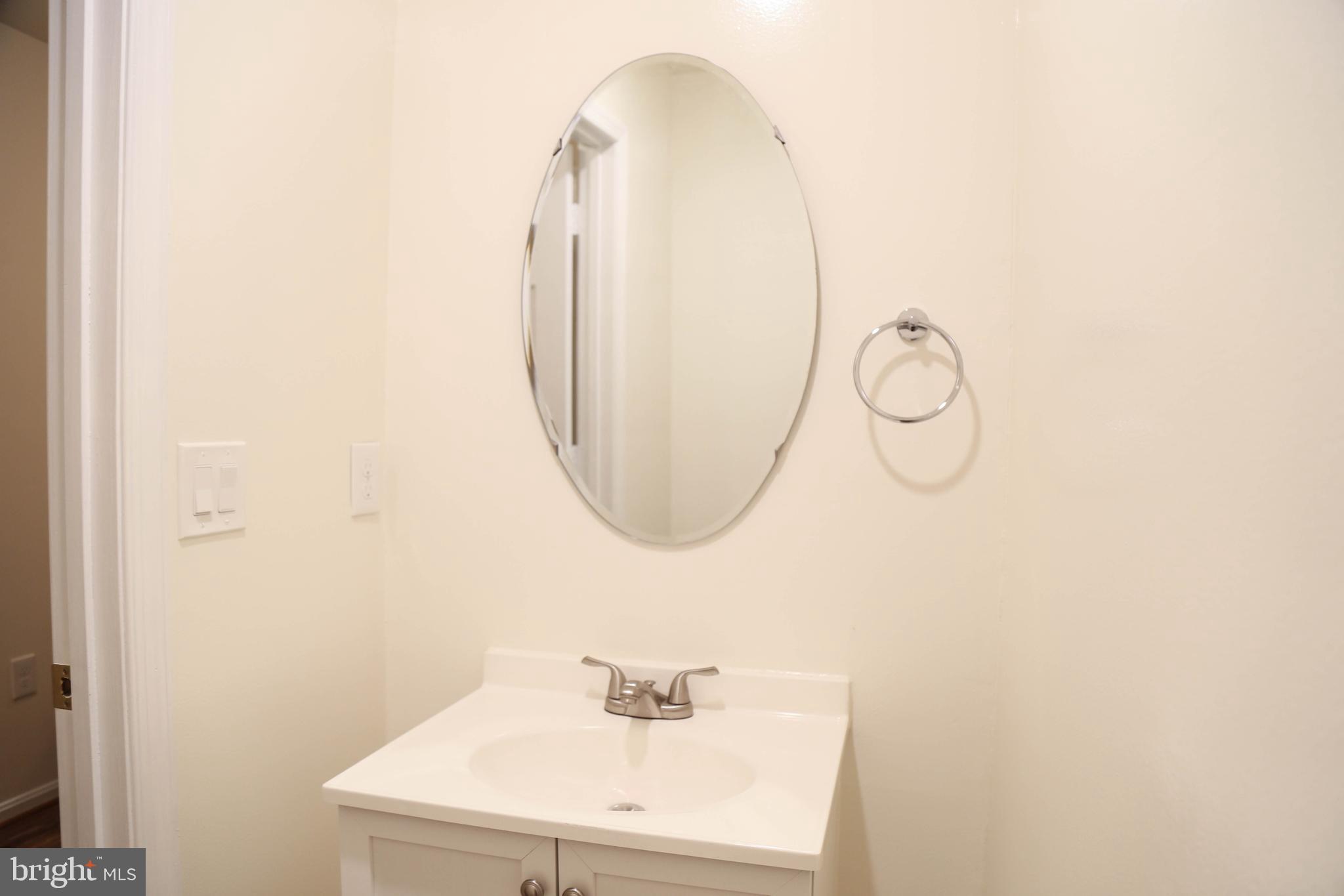 8461 Tackhouse Loop Gainesville, VA 20155 - Photo 29 of 39 a bathroom with a sink and a mirror