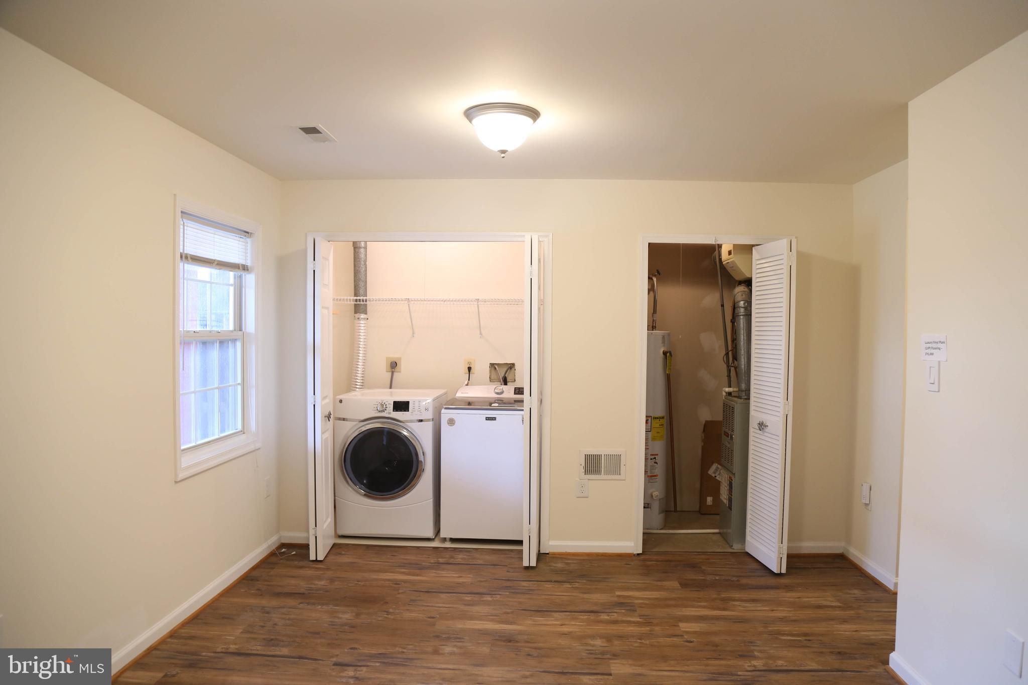 8461 Tackhouse Loop Gainesville, VA 20155 - Photo 32 of 39 a view of a livingroom with wooden floor and a large window