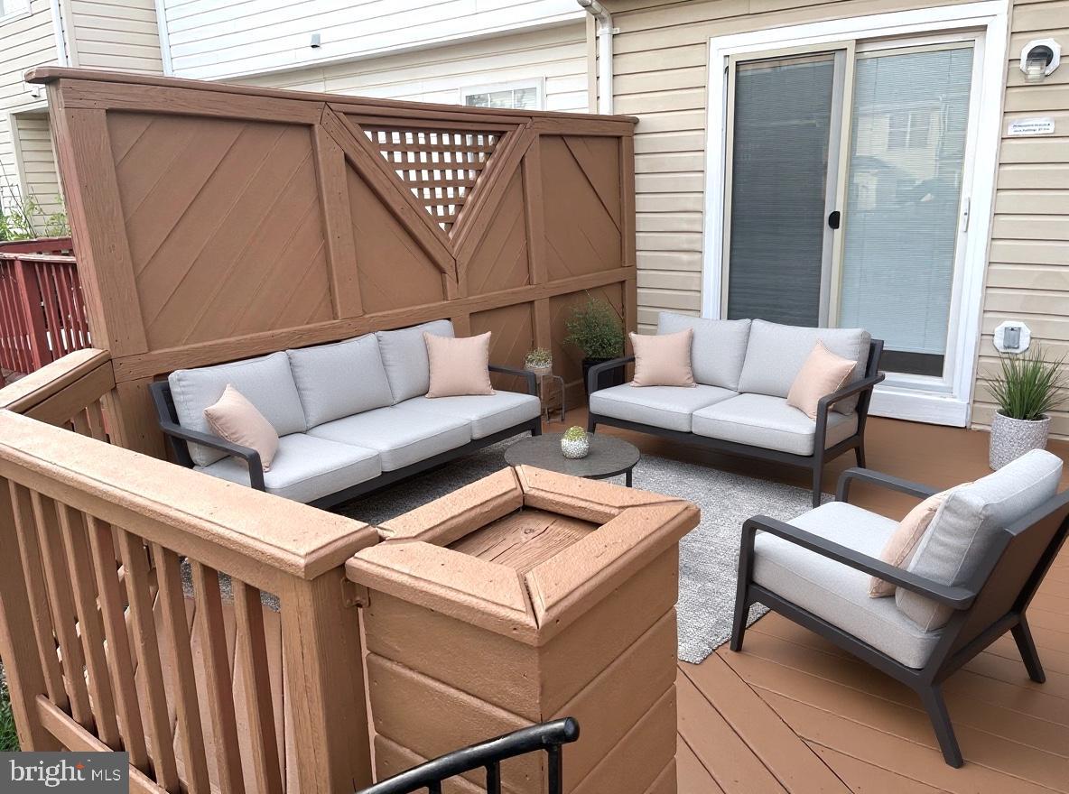 8461 Tackhouse Loop Gainesville, VA 20155 - Photo 34 of 39 a view of a patio with couches and a potted plant on a table