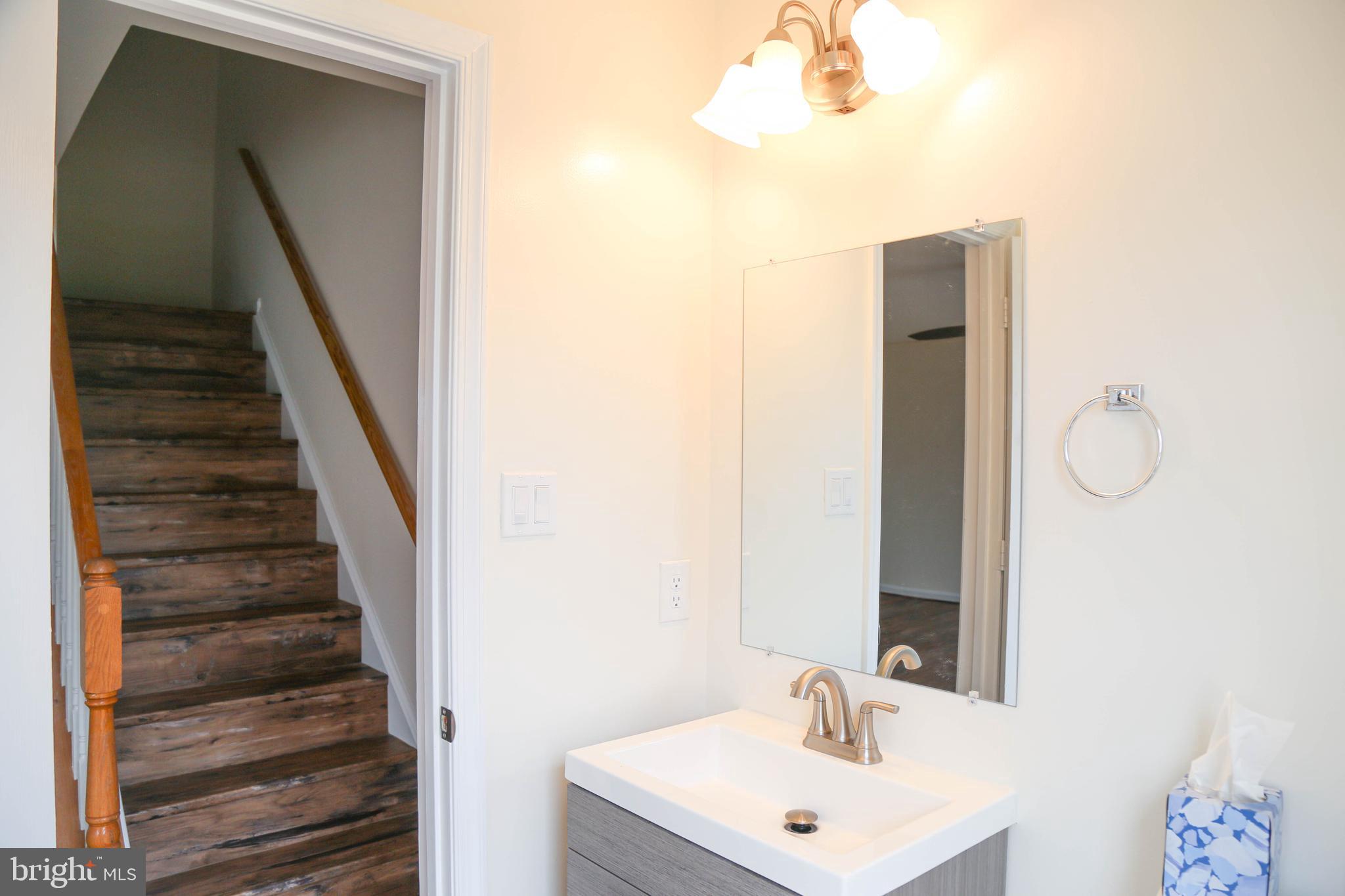 8461 Tackhouse Loop Gainesville, VA 20155 - Photo 5 of 39 a bathroom with a sink and a mirror