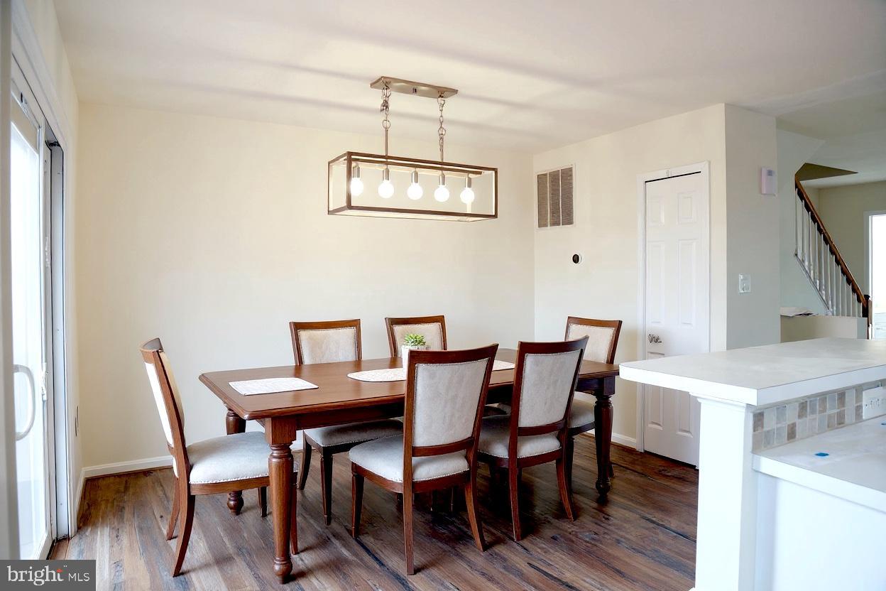 8461 Tackhouse Loop Gainesville, VA 20155 - Photo 6 of 39 a view of a dining room with furniture and wooden floor