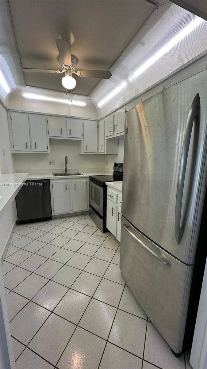 a kitchen with a refrigerator and a sink