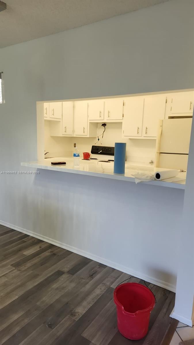 4174 Inverrary Drive, Unit 311 Lauderhill, FL 33319 - Photo 11 of 29 a view of a kitchen with a window and wooden floor