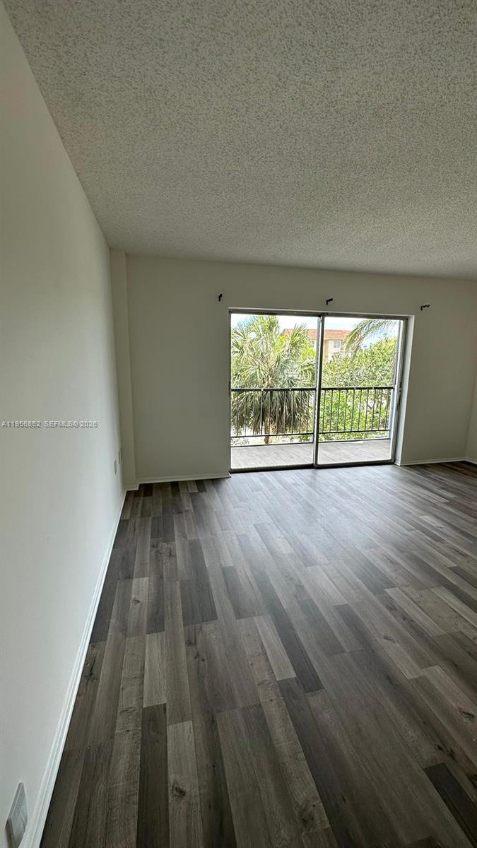 4174 Inverrary Drive, Unit 311 Lauderhill, FL 33319 - Photo 15 of 29 wooden floor in an empty room with a window