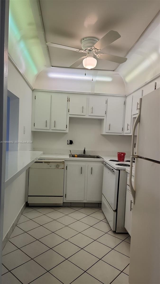 4174 Inverrary Drive, Unit 311 Lauderhill, FL 33319 - Photo 2 of 29 a kitchen with a refrigerator and cabinets