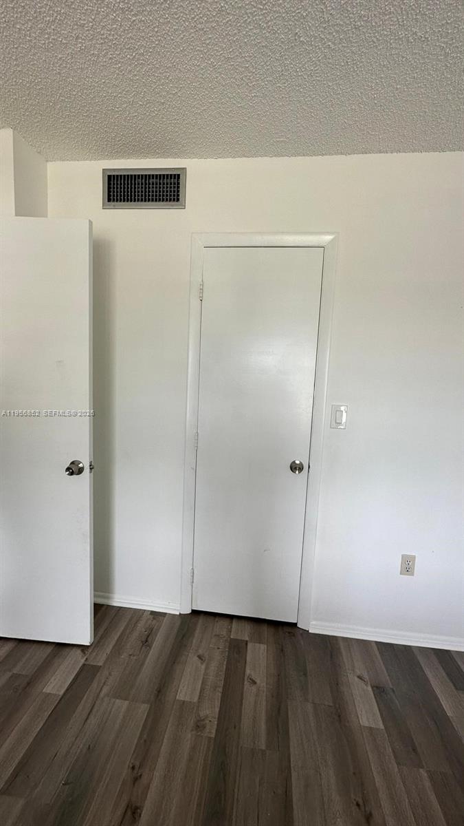 4174 Inverrary Drive, Unit 311 Lauderhill, FL 33319 - Photo 23 of 29 a view of an empty room with wooden floor and closet