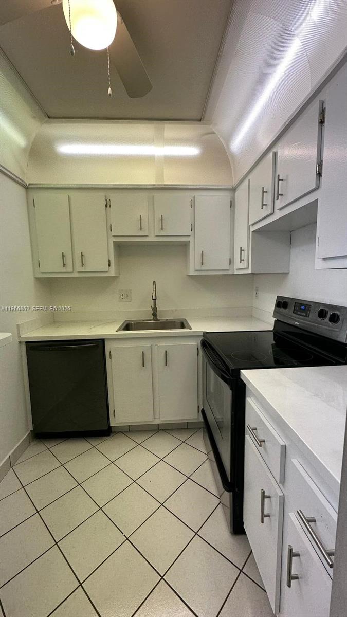 4174 Inverrary Drive, Unit 311 Lauderhill, FL 33319 - Photo 27 of 29 a kitchen with a cabinets and white appliances