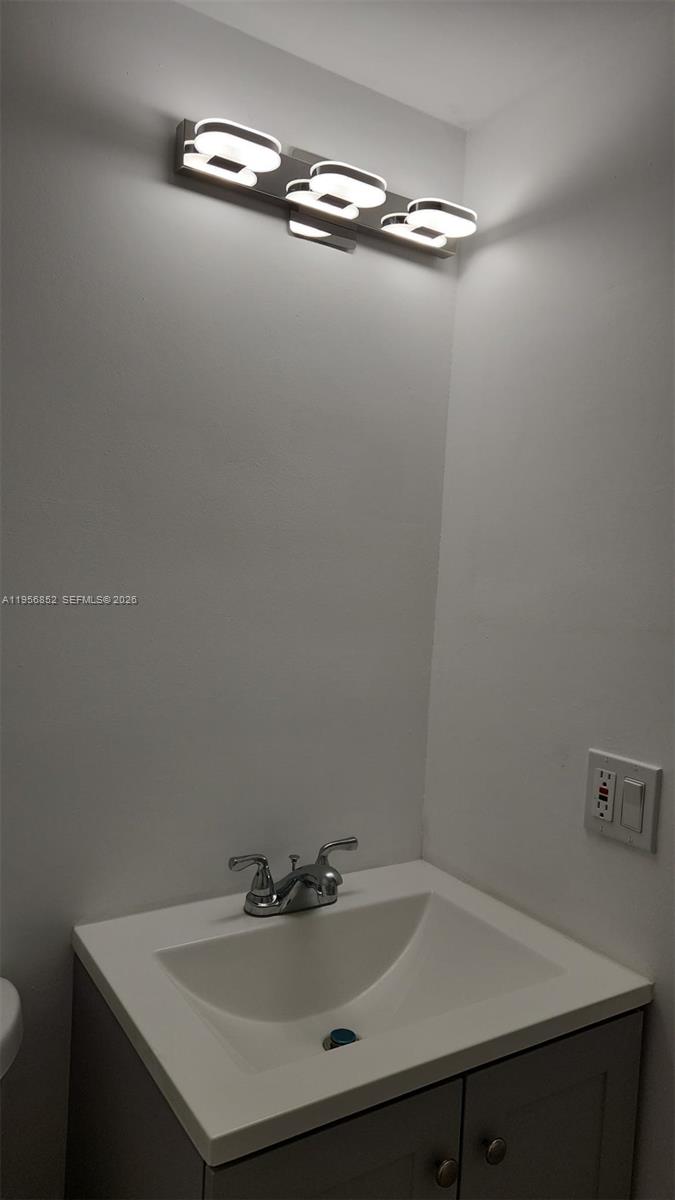 4174 Inverrary Drive, Unit 311 Lauderhill, FL 33319 - Photo 5 of 29 a bathroom with a sink and a mirror