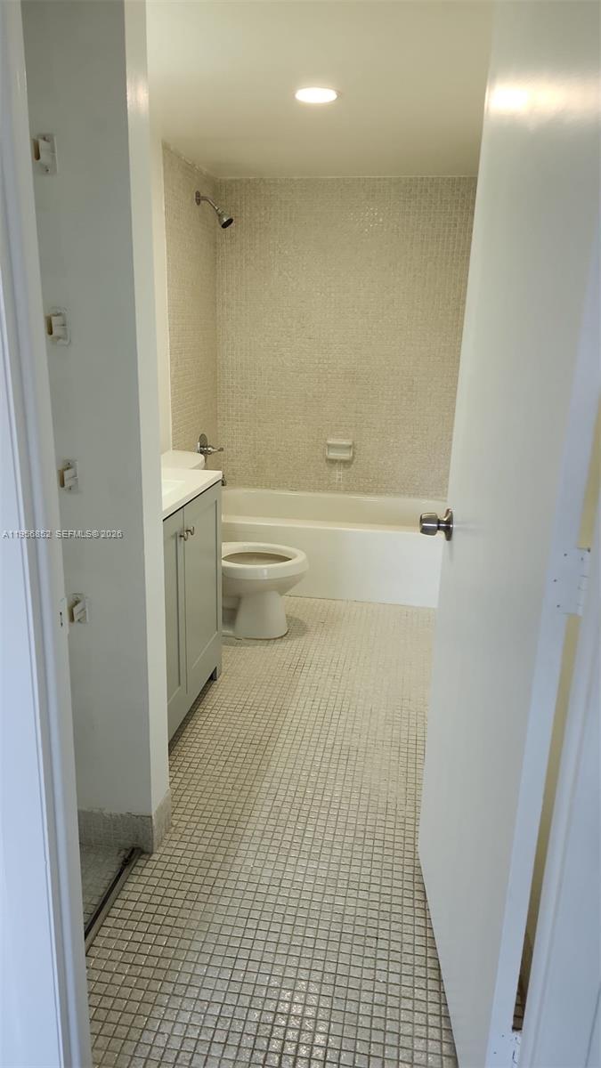 4174 Inverrary Drive, Unit 311 Lauderhill, FL 33319 - Photo 6 of 29 a bathroom with a sink a toilet and a shower