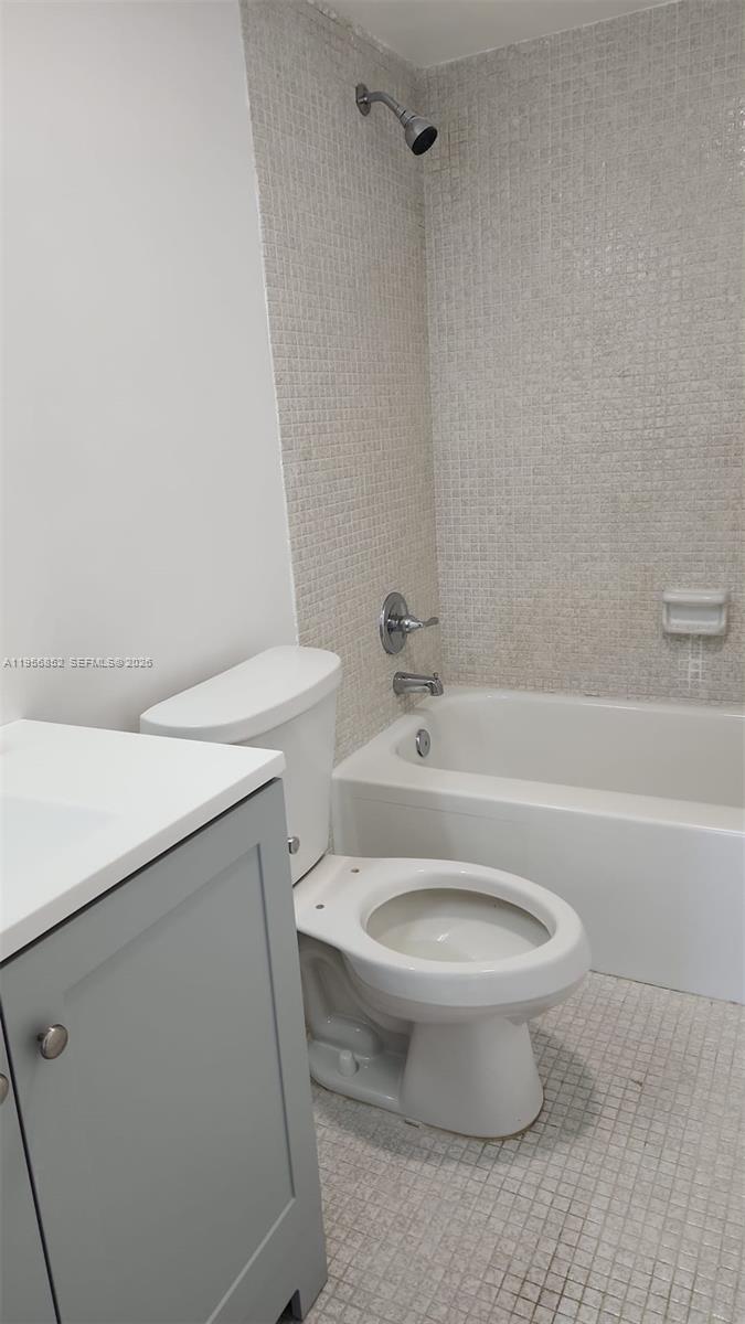 4174 Inverrary Drive, Unit 311 Lauderhill, FL 33319 - Photo 7 of 29 a white toilet sitting next to a bath tub