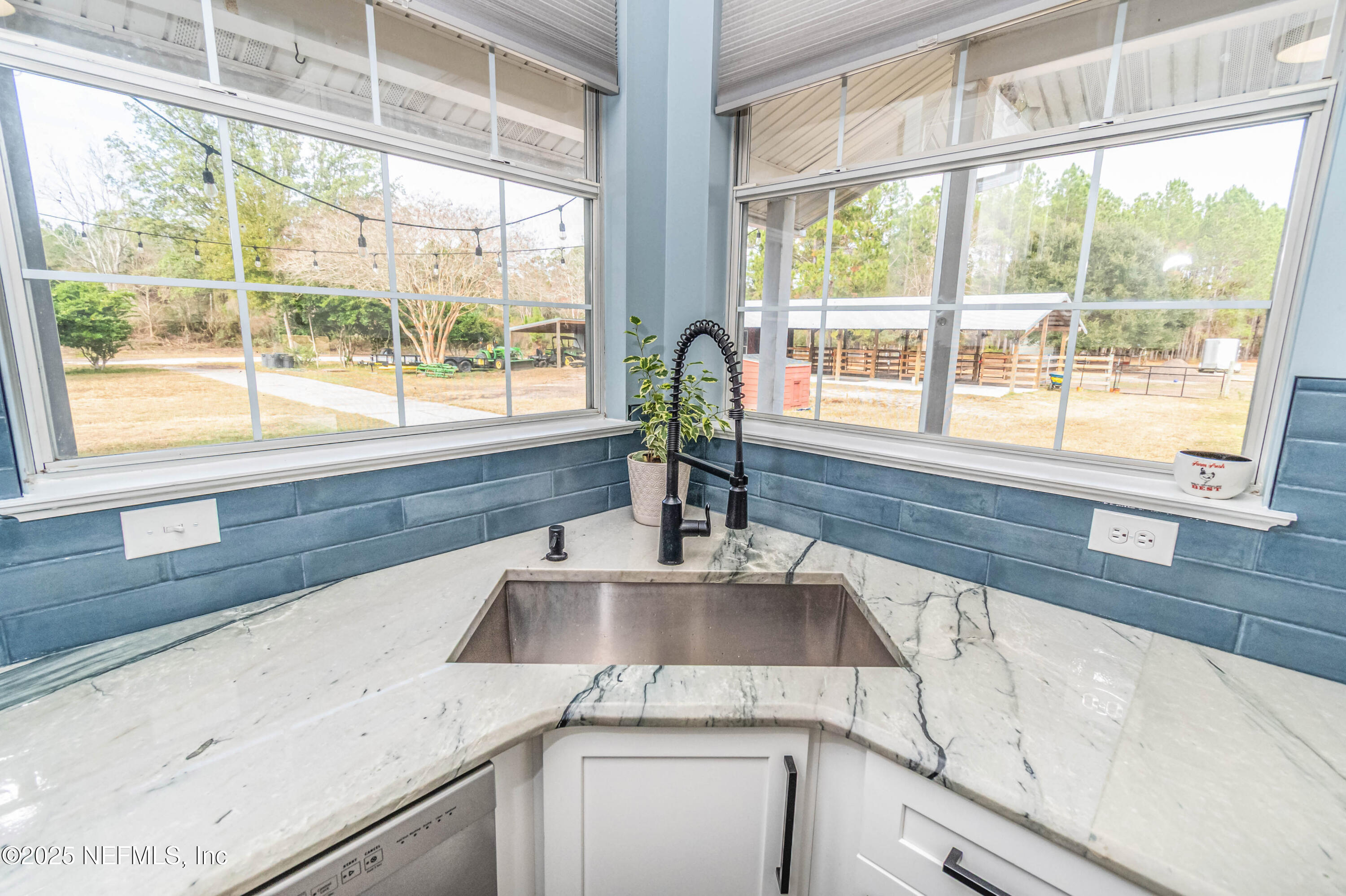 8219 Mud Lake Road Macclenny, FL 32063 - Photo 25 of 105 a kitchen with granite countertop a sink and a large window