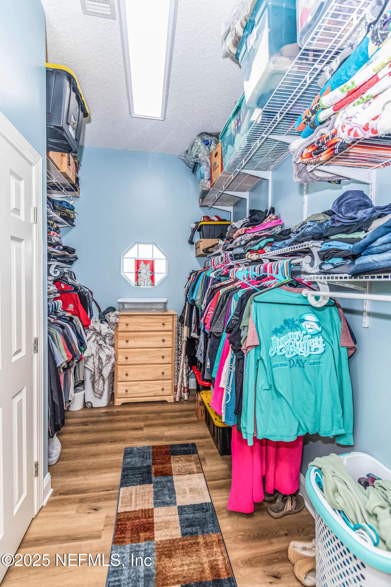8219 Mud Lake Road Macclenny, FL 32063 - Photo 43 of 105 a view of walk in closet with clothes and shoes