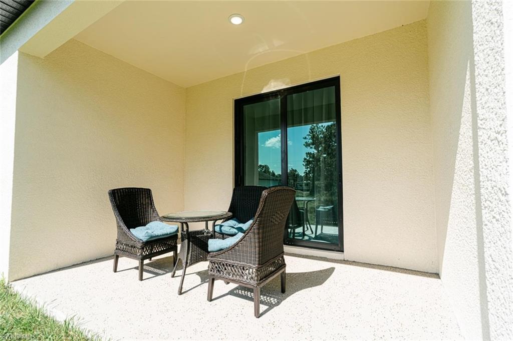 907 Homestead Road South Lehigh Acres, FL 33974 - Photo 4 of 43 Covered outdoor patio with textured wall finish and recessed lighting