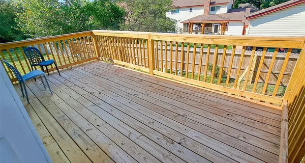 a view of a balcony with wooden floor
