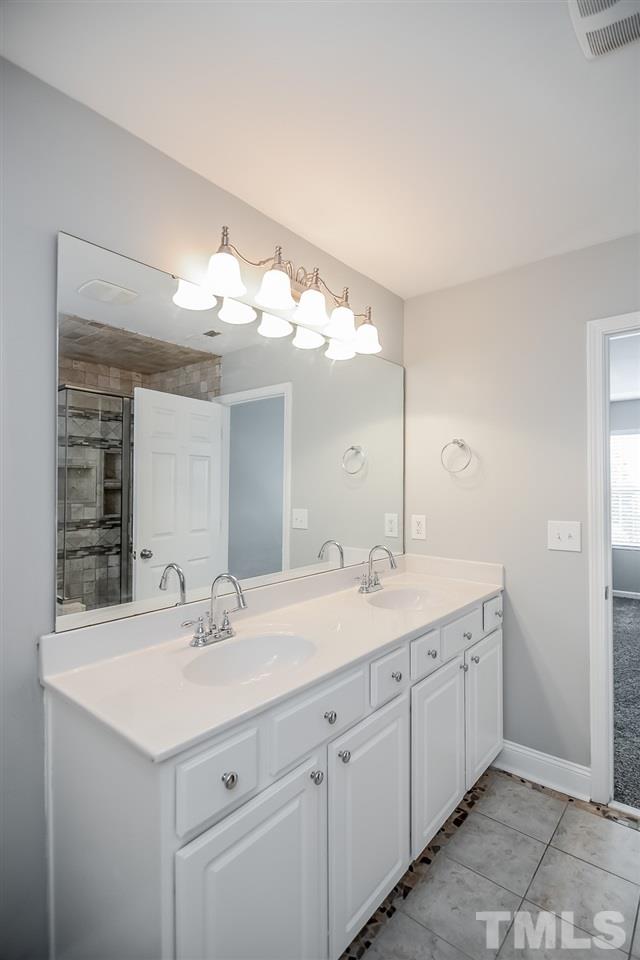 3020 Settle In Lane Raleigh, NC 27614 - Photo 11 of 25 Double Vanities, Tile Floors, Tile Shower Walls & Tub Surround.