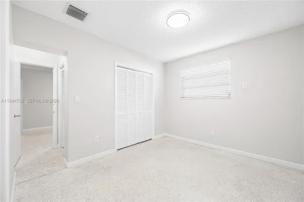 an empty room with a empty space and windows