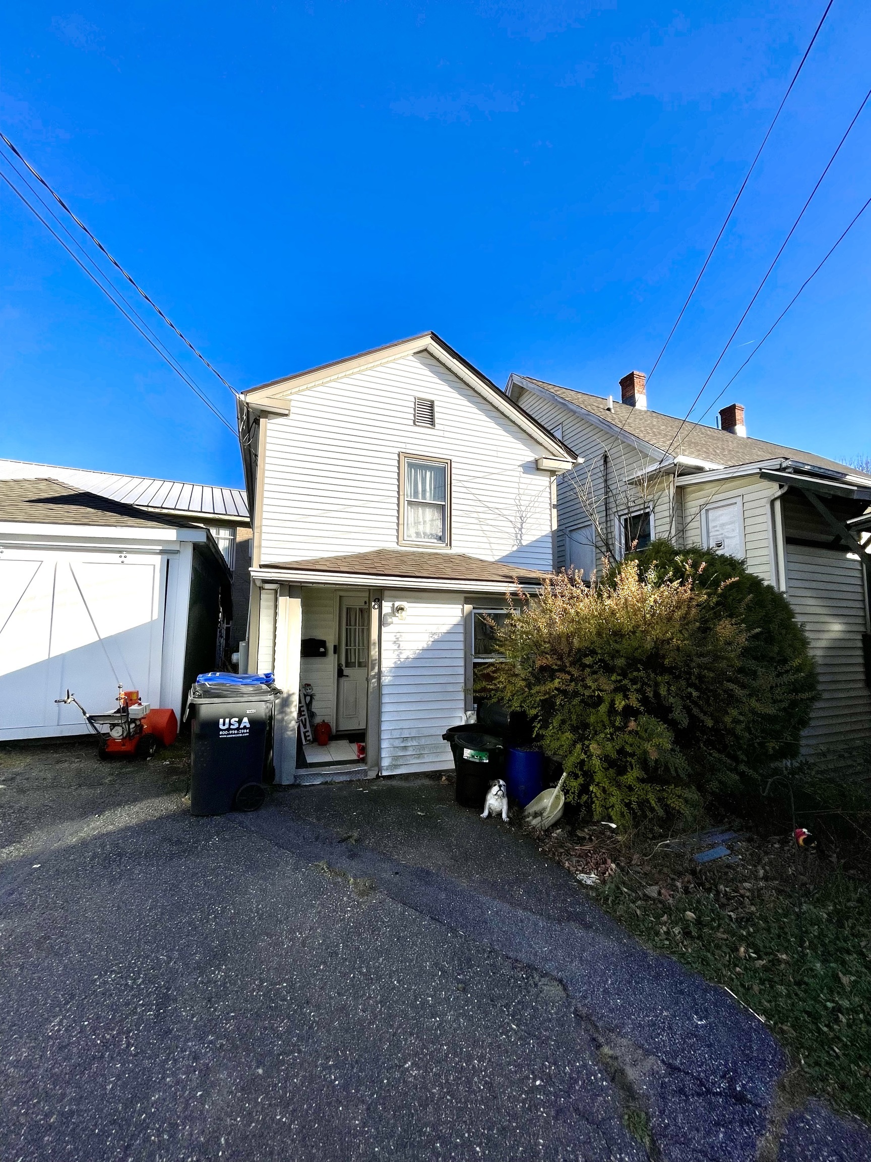 a car parked in front of white house