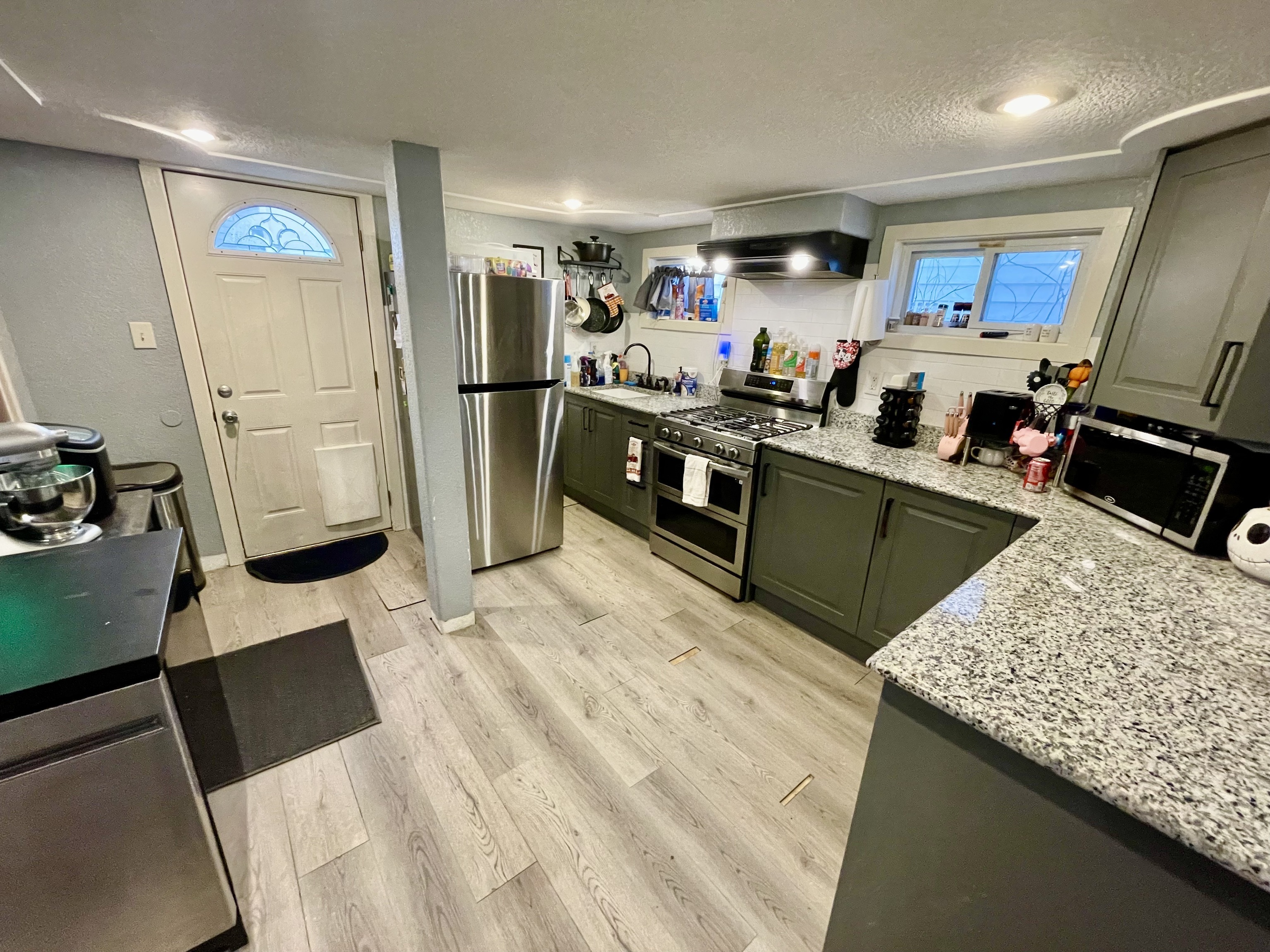 8 Oak Street Winchester, CT 06098 - Photo 4 of 11 a kitchen with stainless steel appliances kitchen island granite countertop a refrigerator stove microwave and sink