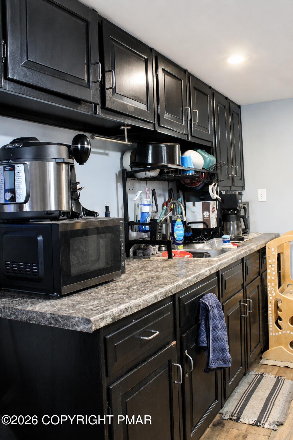 448 East Kline Avenue Lansford, PA 18232 - Photo 9 of 14 a kitchen with stainless steel appliances granite countertop a sink wooden cabinets and a stove