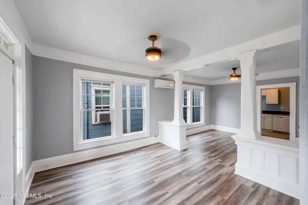 wooden floor in an empty room with a window