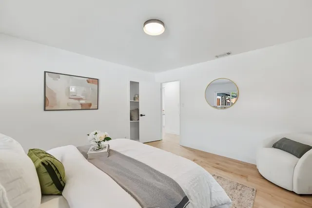 a bedroom with bed and a couch