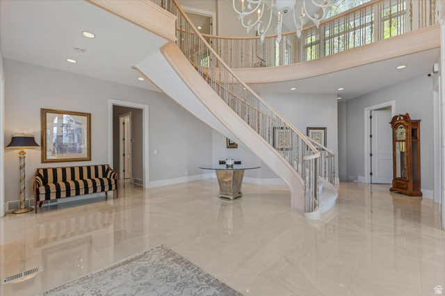 3222 Eagle View Circle Sandy, UT 84092 - Photo 5 of 60 Staircase featuring a high ceiling, a chandelier, and marble finish floors