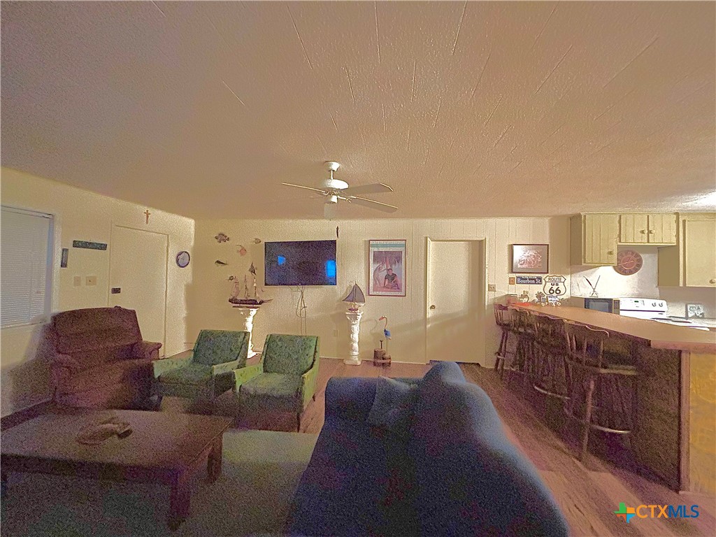 1008 Adams Avenue Port O'Connor, TX 77982 - Photo 16 of 43 a living room with furniture and a flat screen tv