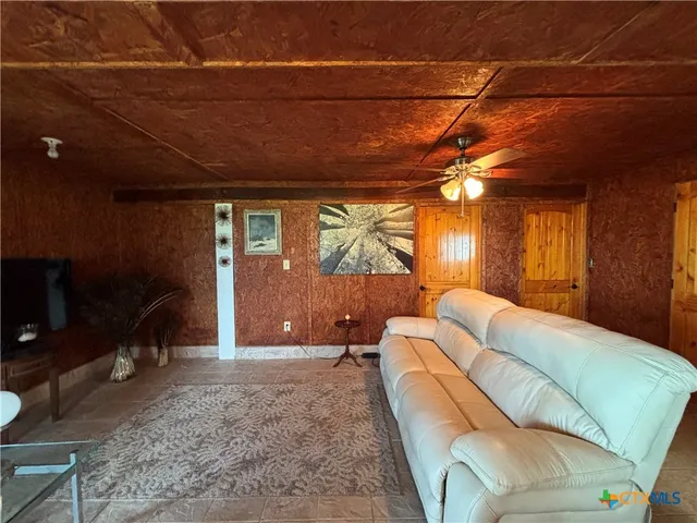 a large white kitchen with a large window