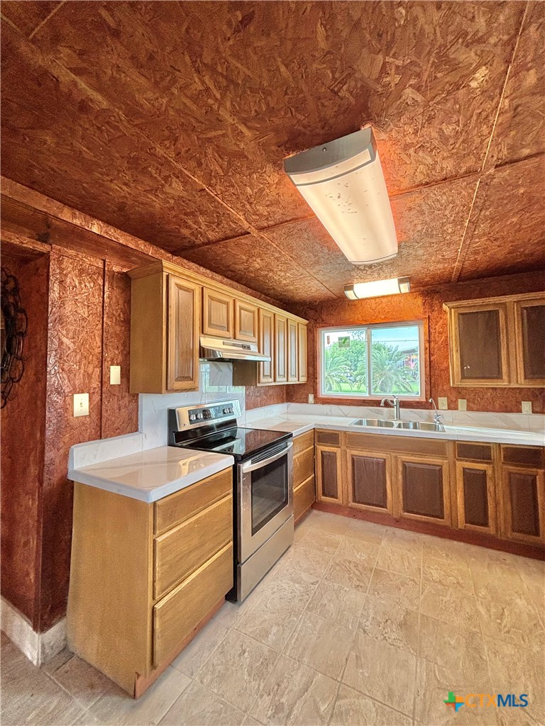 1008 Adams Avenue Port O'Connor, TX 77982 - Photo 29 of 43 a kitchen with stainless steel appliances granite countertop a stove a sink and a refrigerator