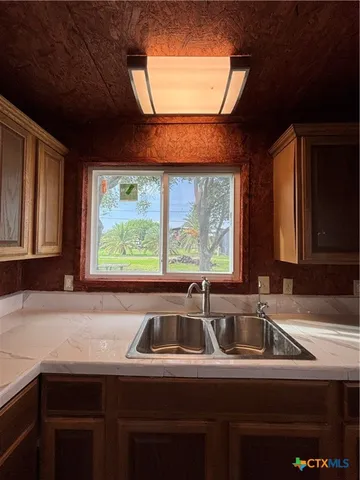 a bathroom with a sink toilet and mirror
