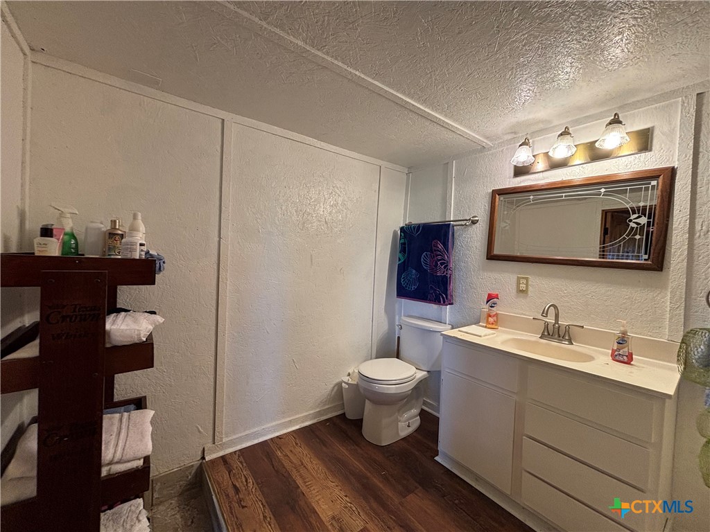 1008 Adams Avenue Port O'Connor, TX 77982 - Photo 33 of 43 a bathroom with a sink toilet and mirror