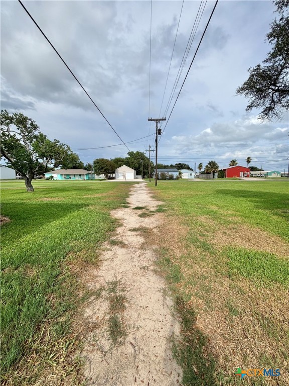 1008 Adams Avenue Port O'Connor, TX 77982 - Photo 43 of 43 a view of a big yard with a table and a chairs