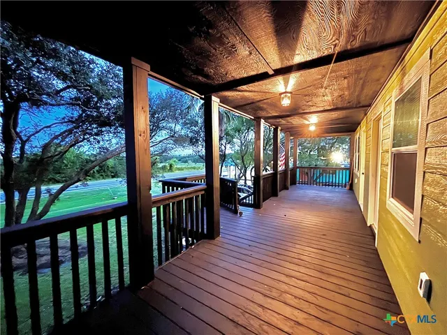 a view of a porch with wooden floor