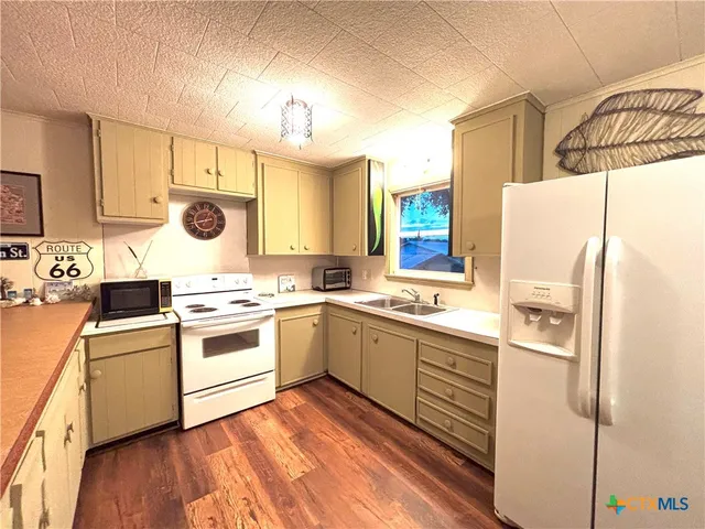 a kitchen with a white cabinets and white appliances