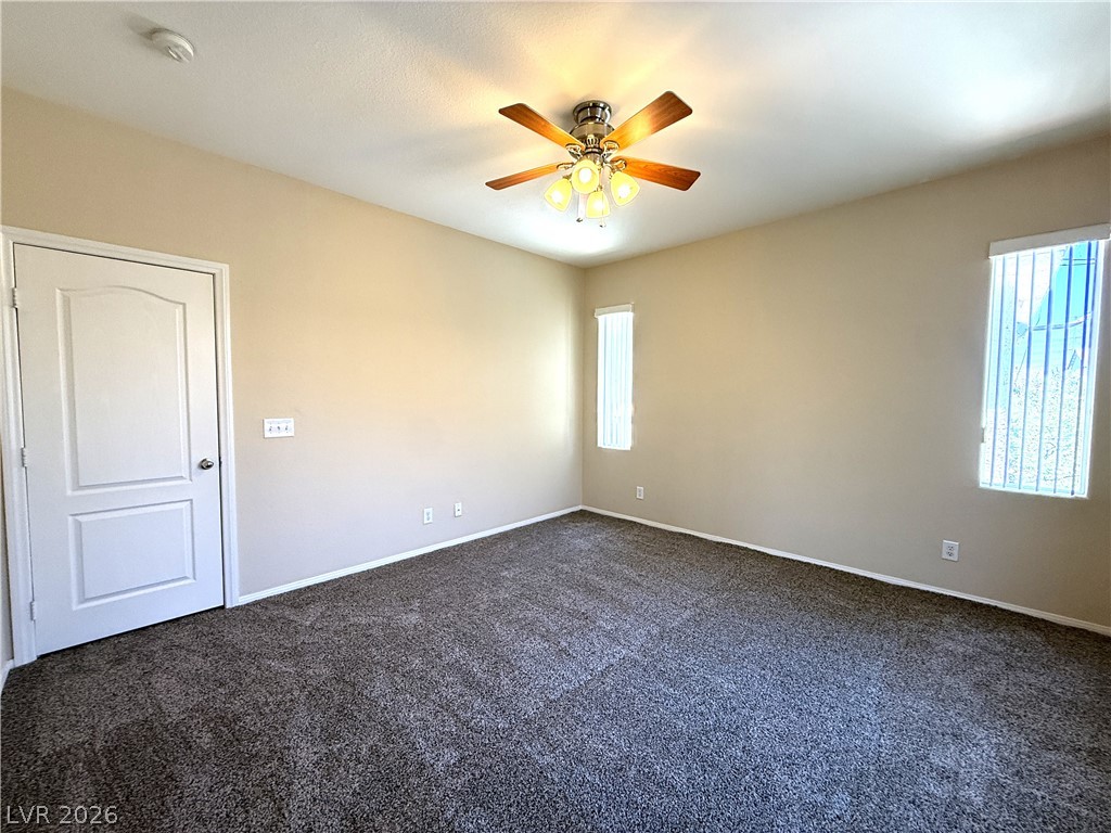 5942 Rampolla Drive Las Vegas, NV 89141 - Photo 11 of 27 A well-lit bedroom offering a blank canvas for personalization with carpeted floors and a modern ceiling fan.