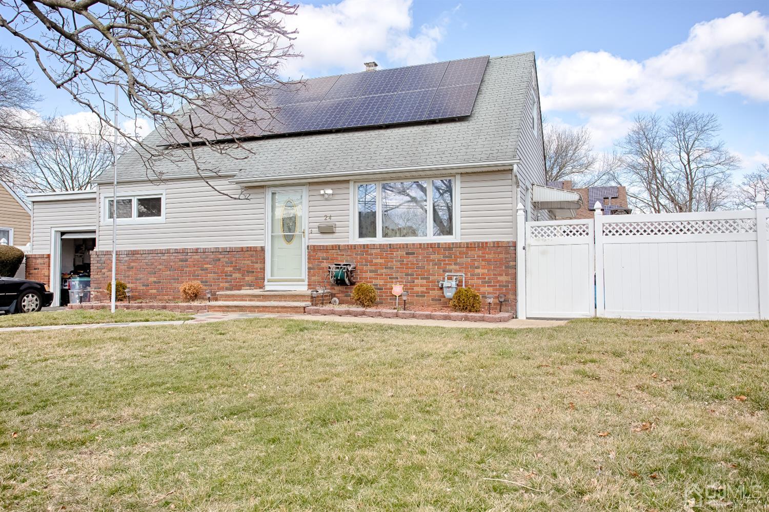 24 Longfield Road New Brunswick, NJ 08901 - Photo 2 of 27 a front view of a house with a yard and garage