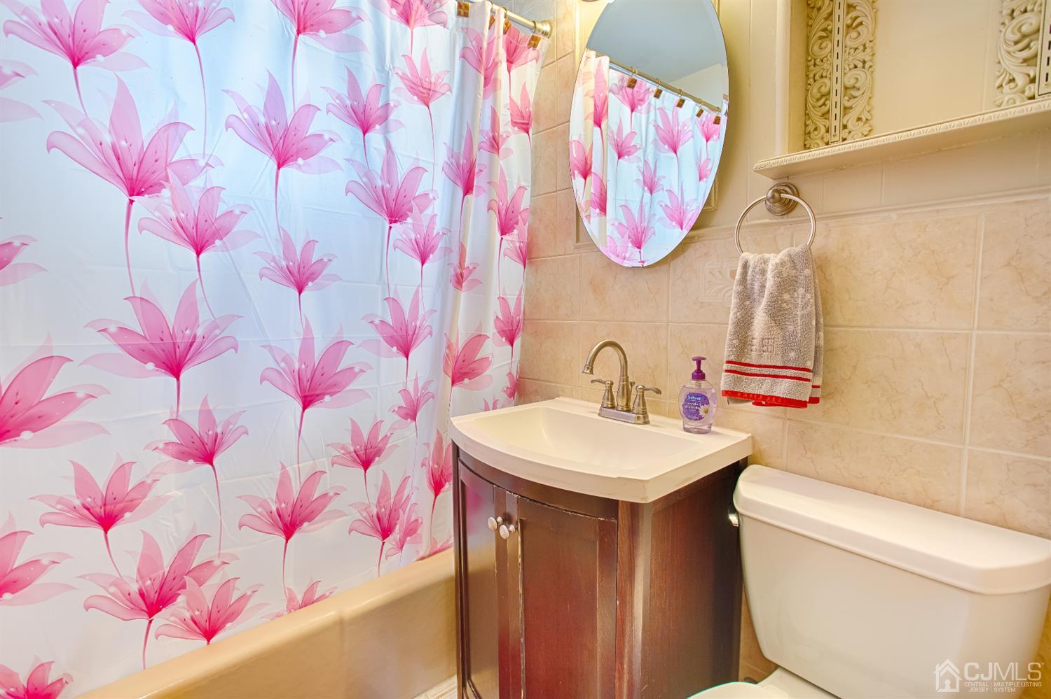 24 Longfield Road New Brunswick, NJ 08901 - Photo 13 of 27 a bathroom with a sink a vanity and a toilet