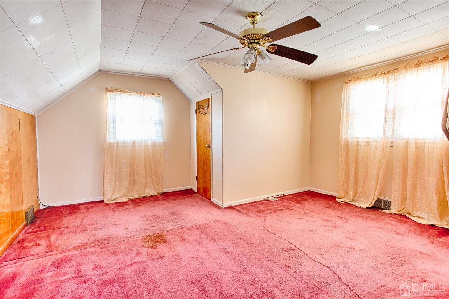 24 Longfield Road New Brunswick, NJ 08901 - Photo 16 of 27 an empty room with windows and a ceiling fan