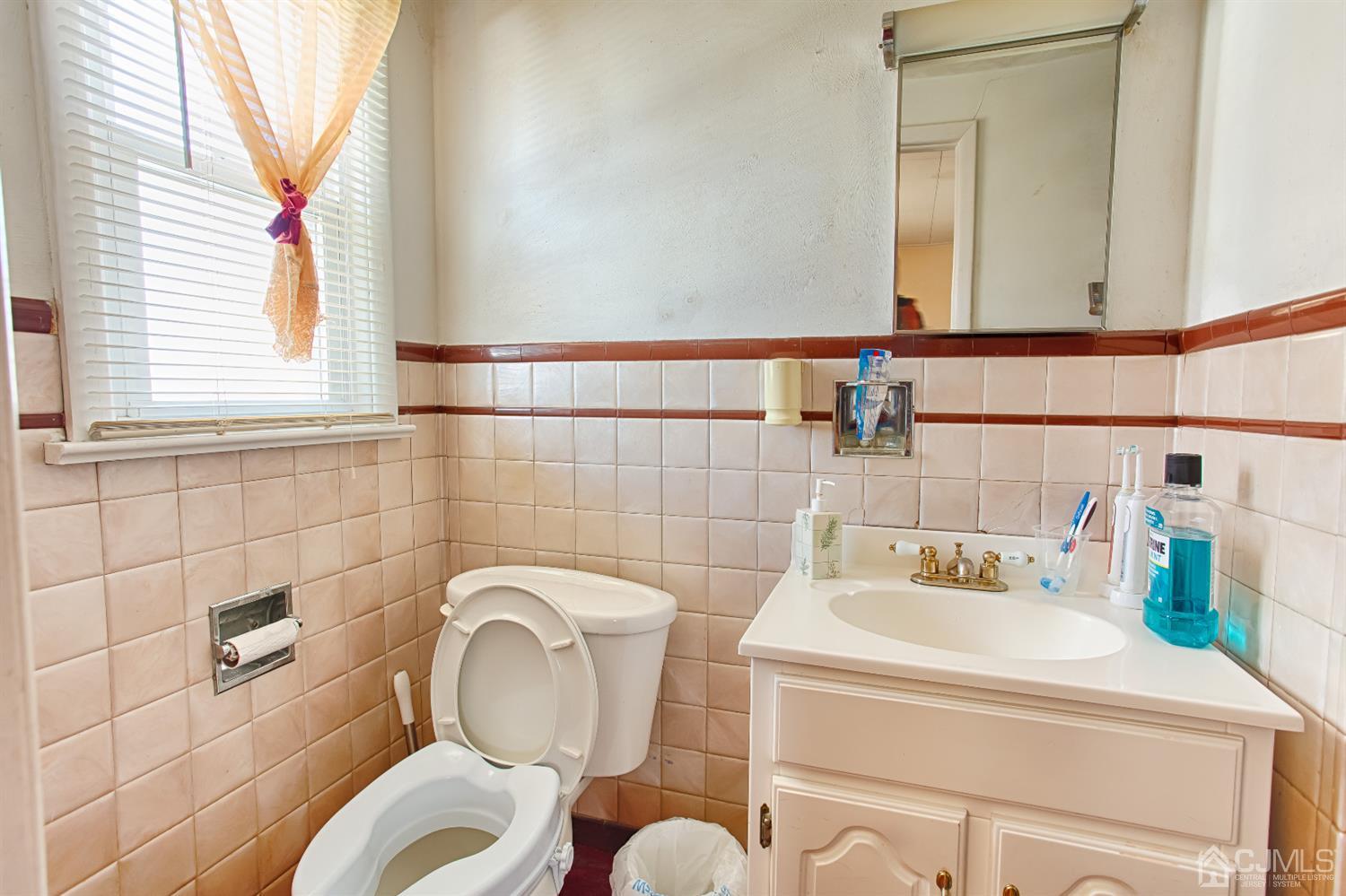 24 Longfield Road New Brunswick, NJ 08901 - Photo 18 of 27 a bathroom with a sink and a mirror