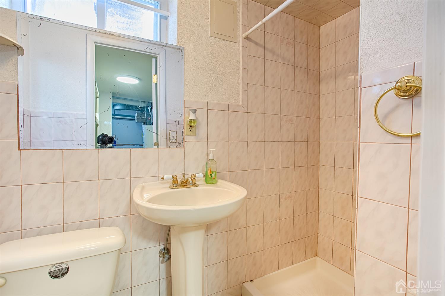 24 Longfield Road New Brunswick, NJ 08901 - Photo 24 of 27 a bathroom with a sink toilet and shower