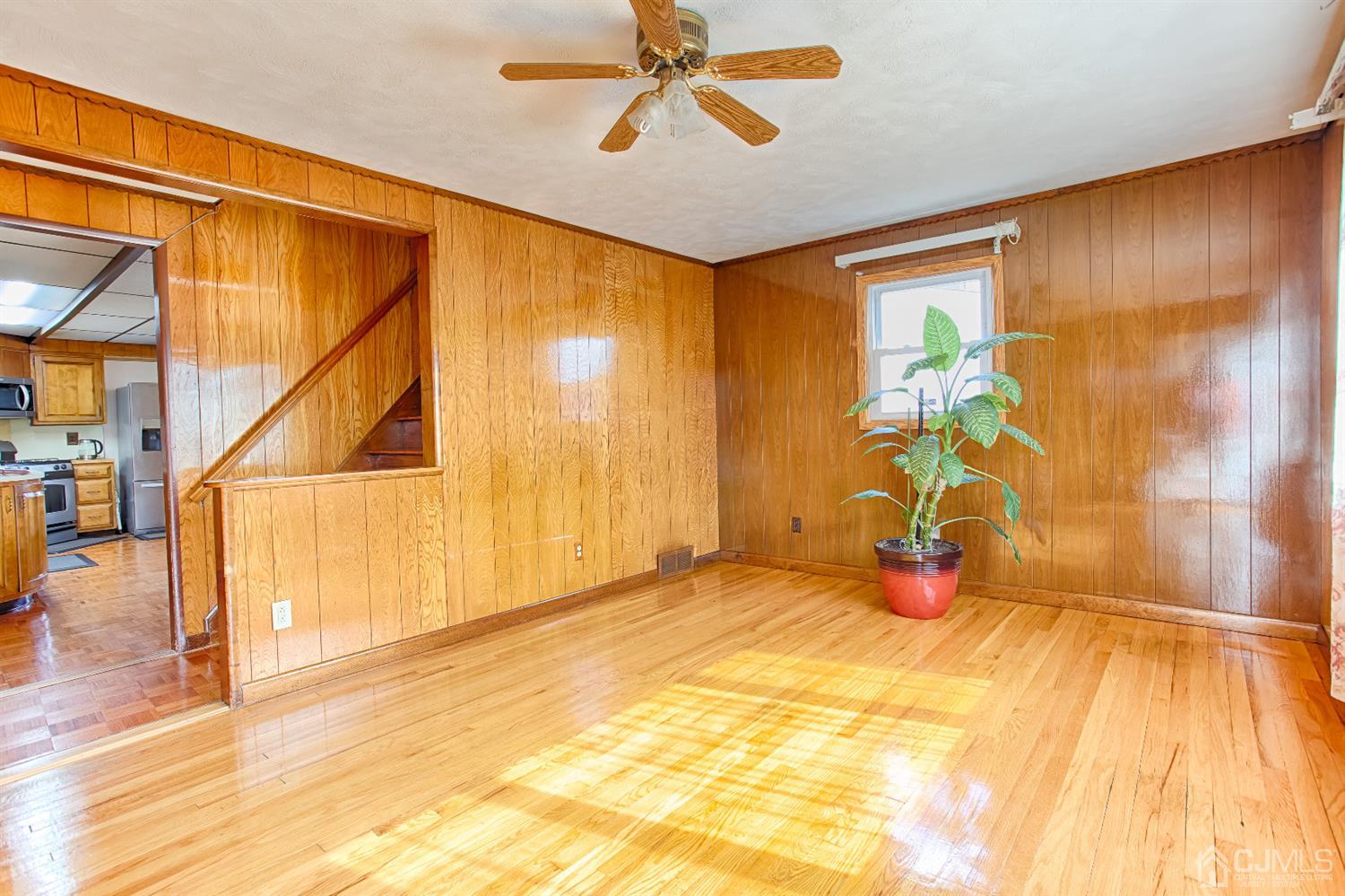 24 Longfield Road New Brunswick, NJ 08901 - Photo 4 of 27 a view of a livingroom with wooden floor and a ceiling fan