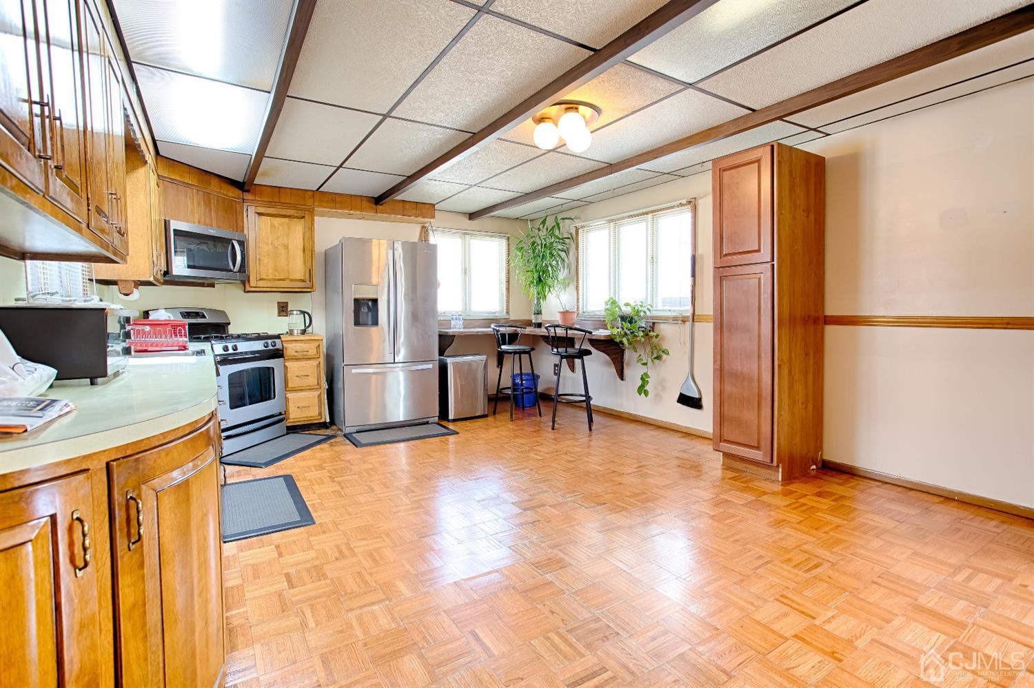 24 Longfield Road New Brunswick, NJ 08901 - Photo 5 of 27 a kitchen with stainless steel appliances granite countertop a refrigerator and a stove top oven