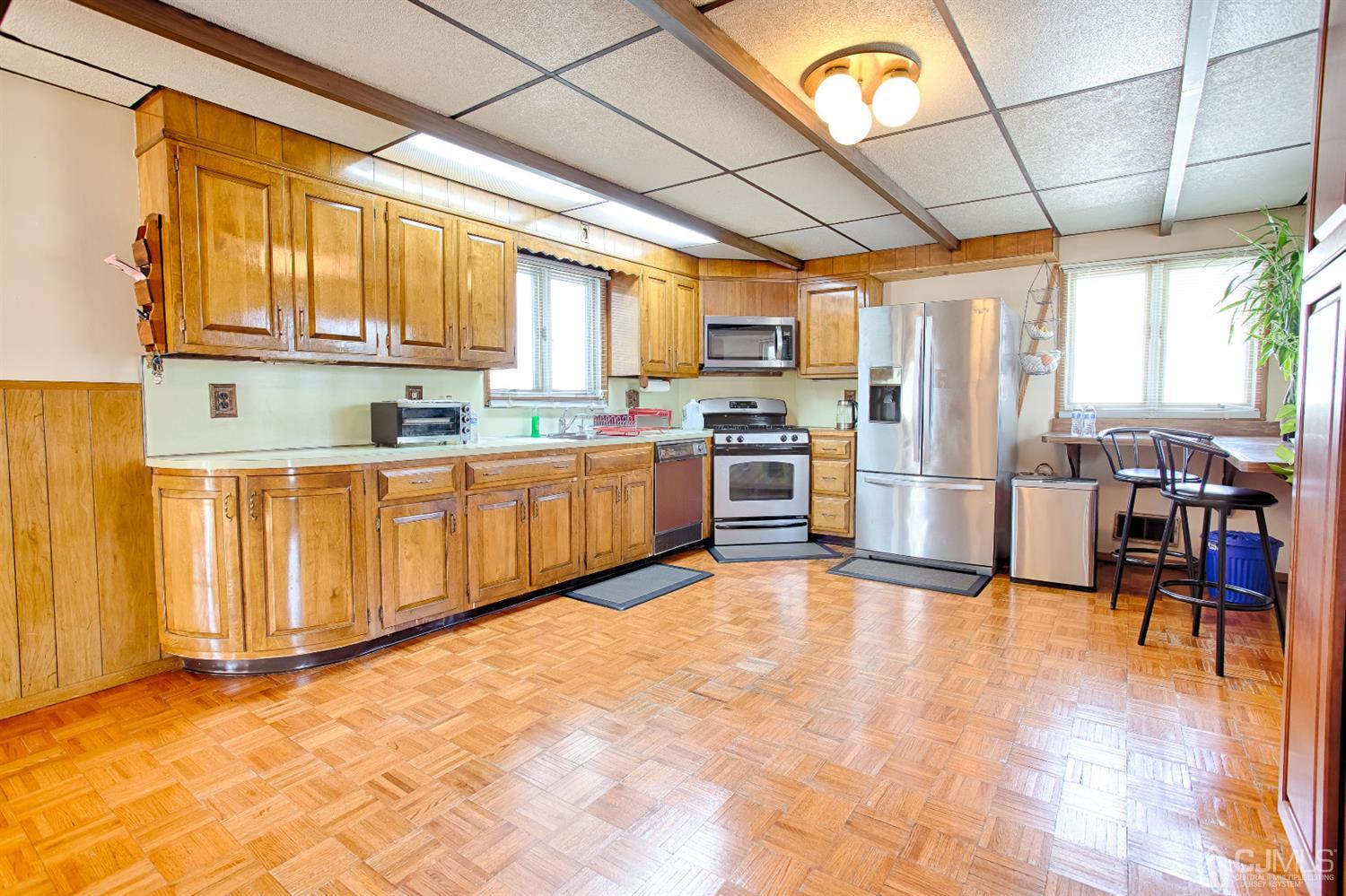 24 Longfield Road New Brunswick, NJ 08901 - Photo 6 of 27 a kitchen with stainless steel appliances granite countertop a stove a sink dishwasher and a refrigerator with cabinets