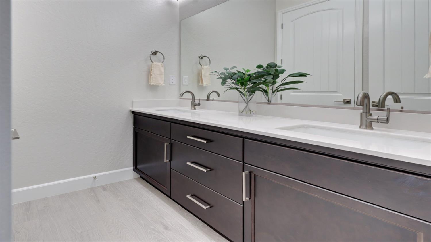 935 Talus Way Madera, CA 93636 - Photo 20 of 34 a bathroom with a sink and a mirror